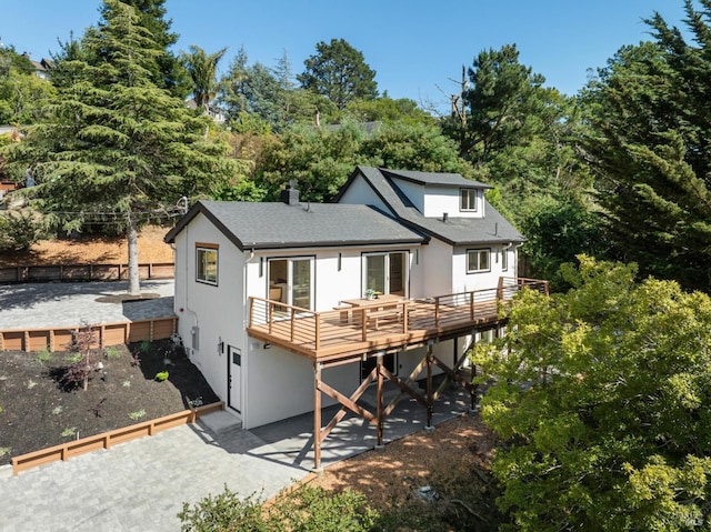532 Pine Crest Rd, Mill Valley, CA 94941 - back of property with stucco siding, a deck, a patio area, a chimney, and a shingled roof