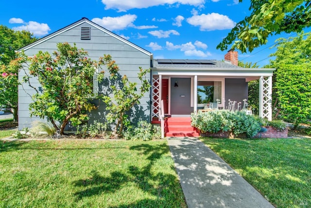 1645 Georgia St, Napa, CA 94559 - view of front of home with covered porch, a front yard, solar panels, and a chimney