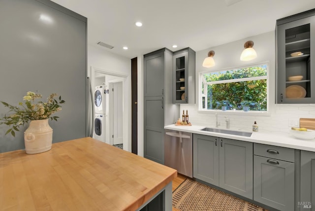 1645 Georgia St, Napa, CA 94559 - kitchen featuring dishwasher, a sink, estacked washer and dryer, gray cabinets, and tasteful backsplash