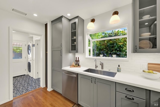 1645 Georgia St, Napa, CA 94559 - kitchen featuring dishwasher, gray cabinets, stacked washer and clothes dryer, a sink, and light wood finished floors