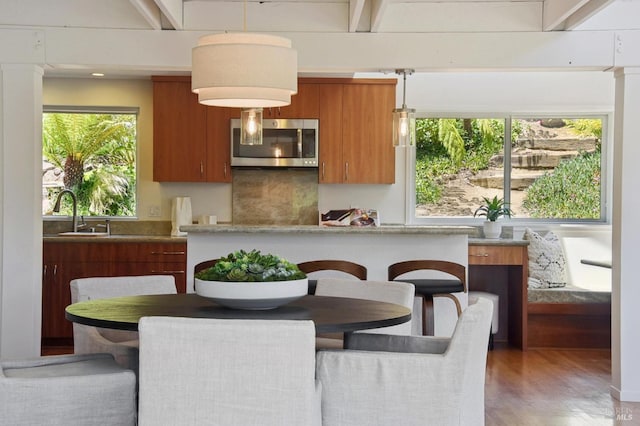 523 W Fairview Ave, Mill Valley, CA 94941 - kitchen featuring stainless steel microwave, a sink, brown cabinets, wood finished floors, and modern cabinets