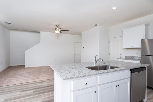 2252 Mia Dr, Newman, CA 95360 - kitchen with stainless steel appliances, a sink, a ceiling fan, open floor plan, and an island with sink