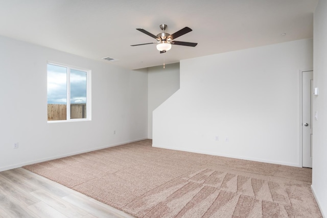 2252 Mia Dr, Newman, CA 95360 - carpeted empty room featuring a ceiling fan, baseboards, and wood finished floors