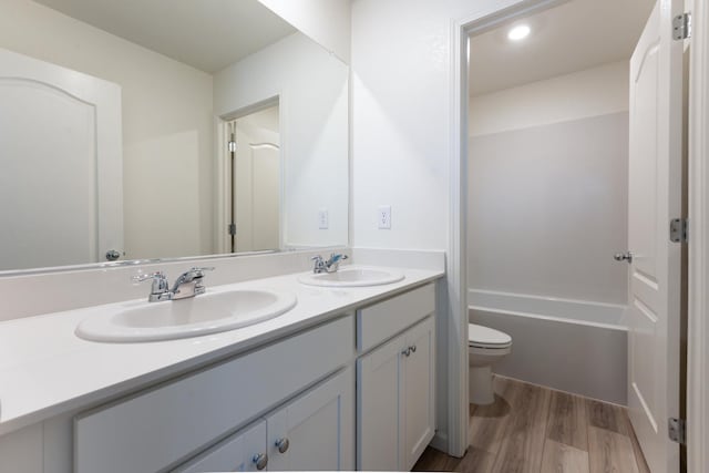2252 Mia Dr, Newman, CA 95360 - full bath with toilet, double vanity, wood finished floors, and a bathtub