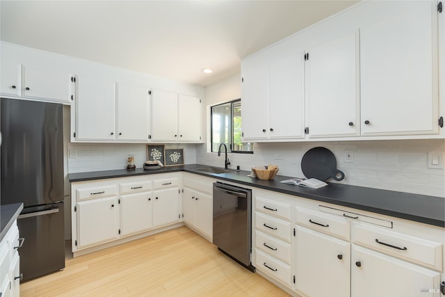 522 Blackstone Dr, San Rafael, CA 94903 - kitchen featuring dishwasher, freestanding refrigerator, a sink, dark countertops, and light wood finished floors