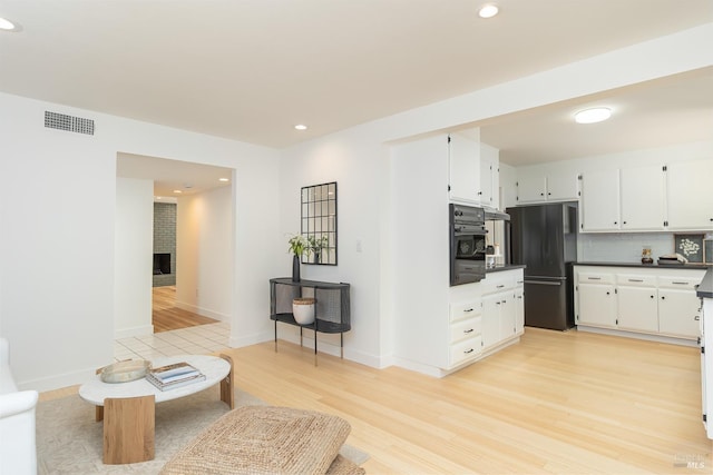 522 Blackstone Dr, San Rafael, CA 94903 - kitchen with black appliances, dark countertops, white cabinetry, recessed lighting, and light wood-style flooring