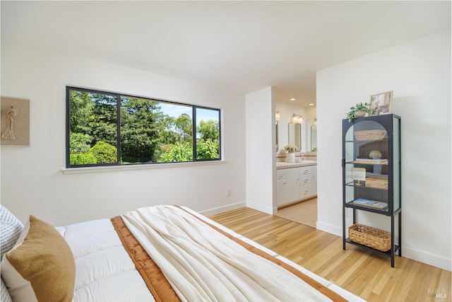 522 Blackstone Dr, San Rafael, CA 94903 - bedroom featuring light wood-style floors, baseboards, and connected bathroom