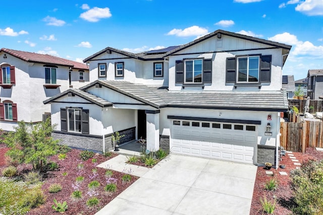 544 Oakham Dr, Vacaville, CA 95687 - view of front of home featuring stone siding, concrete driveway, an attached garage, and roof mounted solar panels