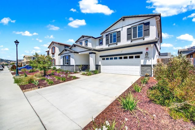 544 Oakham Dr, Vacaville, CA 95687 - view of front of house featuring a garage, stone siding, driveway, and stucco siding
