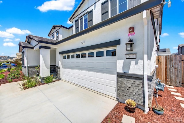 544 Oakham Dr, Vacaville, CA 95687 - view of side of home with a garage, stone siding, stucco siding, and concrete driveway