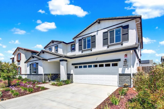 544 Oakham Dr, Vacaville, CA 95687 - view of front of home featuring stone siding, a garage, driveway, stucco siding, and board and batten siding