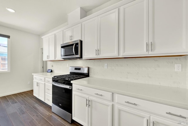 544 Oakham Dr, Vacaville, CA 95687 - kitchen featuring stainless steel appliances, white cabinets, decorative backsplash, light countertops, and dark wood finished floors