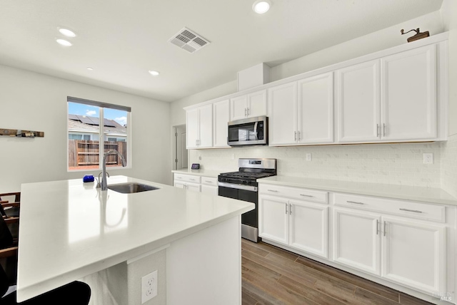544 Oakham Dr, Vacaville, CA 95687 - kitchen with stainless steel appliances, a sink, white cabinetry, decorative backsplash, and recessed lighting