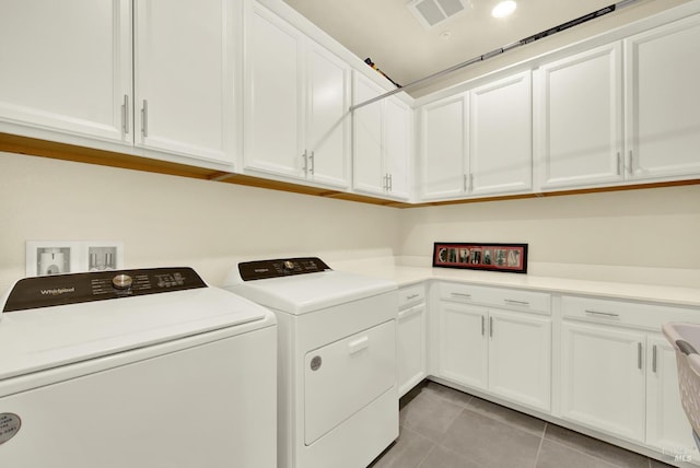 544 Oakham Dr, Vacaville, CA 95687 - laundry area featuring washer and dryer, light tile patterned floors, and cabinet space
