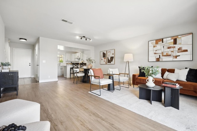 1259 Royal Oak Ter Unit A, Novato, CA 94947 - living area featuring light wood finished floors, baseboards, and rail lighting