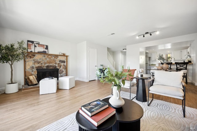 1259 Royal Oak Ter Unit A, Novato, CA 94947 - living area featuring stairs, light wood-type flooring, a fireplace, and baseboards
