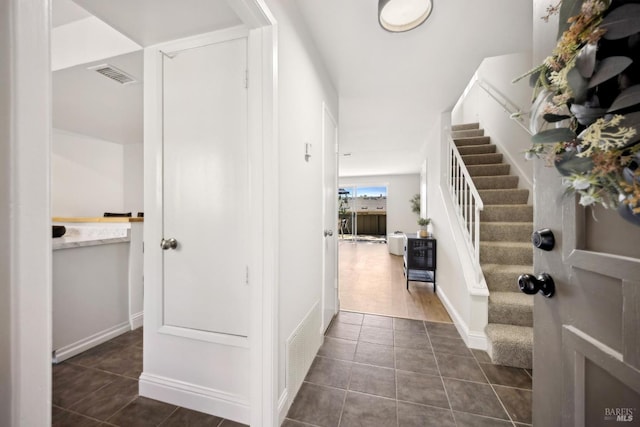 1259 Royal Oak Ter Unit A, Novato, CA 94947 - foyer entrance with dark tile patterned floors, stairs, and baseboards