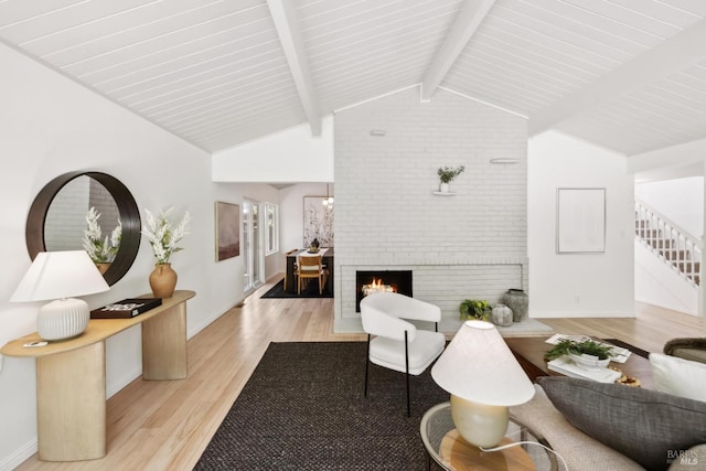 2647 Heatherstone Dr, San Rafael, CA 94903 - living room with light wood finished floors, baseboards, a brick fireplace, and stairway