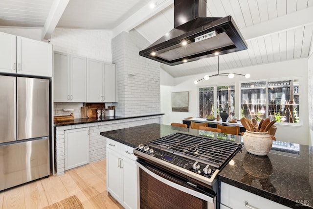 2647 Heatherstone Dr, San Rafael, CA 94903 - kitchen featuring appliances with stainless steel finishes, wall chimney exhaust hood, light wood-style floors, and dark stone countertops