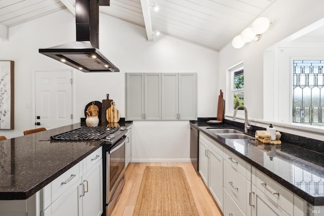 2647 Heatherstone Dr, San Rafael, CA 94903 - kitchen with wall chimney range hood, appliances with stainless steel finishes, a sink, a peninsula, and light wood-style flooring