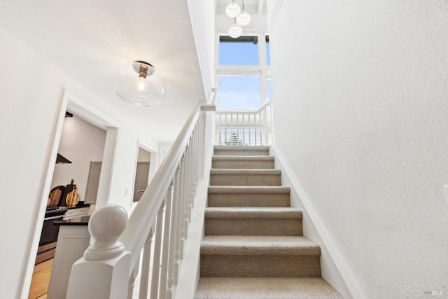 2647 Heatherstone Dr, San Rafael, CA 94903 - stairway featuring plenty of natural light, a textured wall, and a towering ceiling