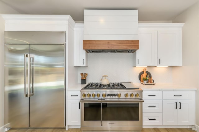 1970 Bent Tree Pl, Santa Rosa, CA 95404 - kitchen with premium appliances, custom exhaust hood, light stone countertops, tasteful backsplash, and white cabinetry