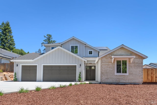 1970 Bent Tree Pl, Santa Rosa, CA 95404 - modern farmhouse style home with a garage, roof mounted solar panels, roof with shingles, driveway, and stone siding