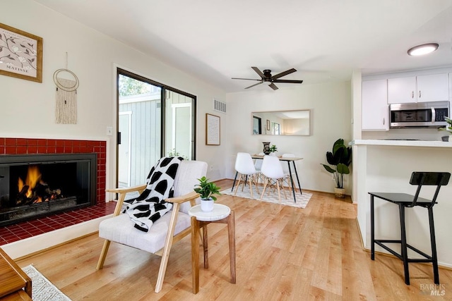 52 Margarita Ter, Novato, CA 94947 - living area featuring a ceiling fan, light wood-type flooring, and a fireplace