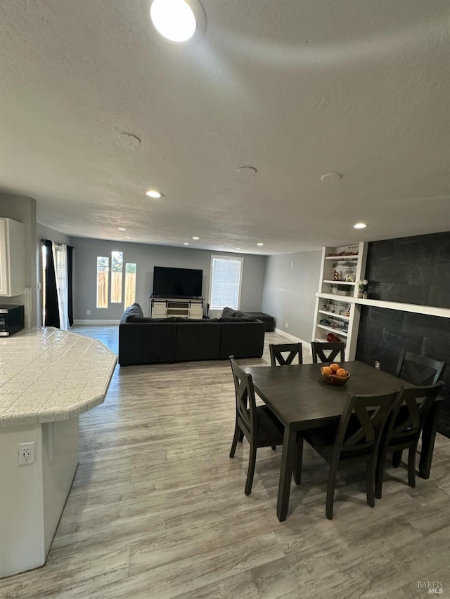69 Eastside Cir, Petaluma, CA 94954 - dining room with baseboards, a textured ceiling, light wood finished floors, recessed lighting, and built in shelves