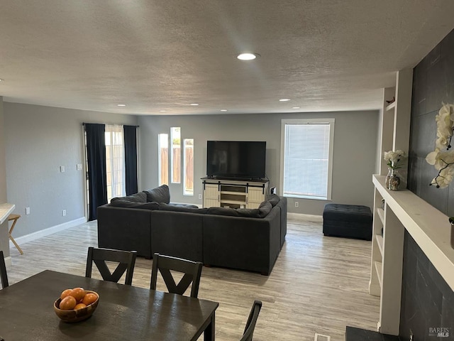 69 Eastside Cir, Petaluma, CA 94954 - living area with light wood finished floors, baseboards, a textured ceiling, and recessed lighting