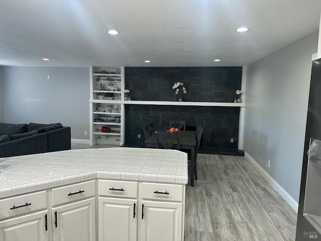 69 Eastside Cir, Petaluma, CA 94954 - kitchen with baseboards, light wood-style flooring, recessed lighting, white cabinetry, and built in features
