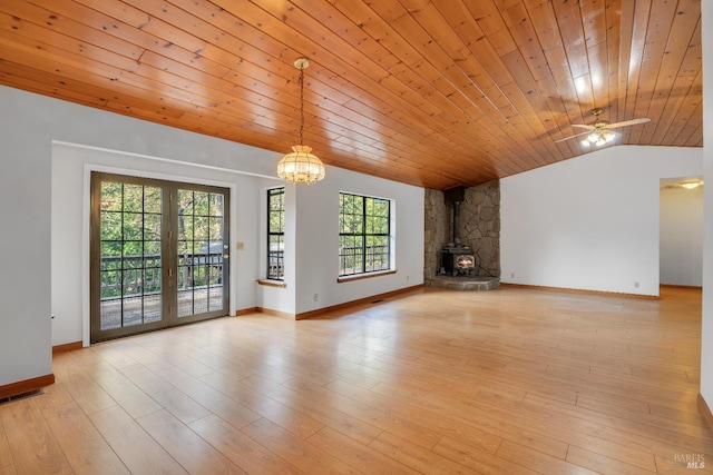 19828 Greenview Dr, Twain Harte, CA 95383 - unfurnished living room featuring a wood stove, lofted ceiling, a chandelier, wood ceiling, and baseboards