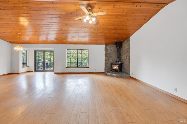 19828 Greenview Dr, Twain Harte, CA 95383 - unfurnished living room featuring a wood stove, light wood finished floors, baseboards, a ceiling fan, and wood ceiling