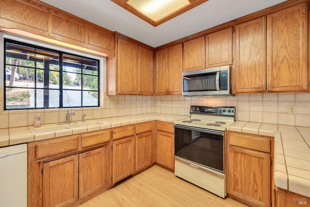 19828 Greenview Dr, Twain Harte, CA 95383 - kitchen featuring stainless steel microwave, electric range oven, dishwasher, a sink, and tasteful backsplash