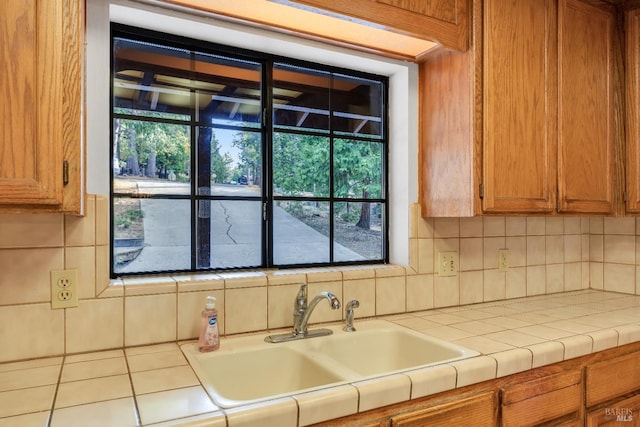 19828 Greenview Dr, Twain Harte, CA 95383 - kitchen with a sink, tile countertops, tasteful backsplash, brown cabinets, and healthy amount of natural light