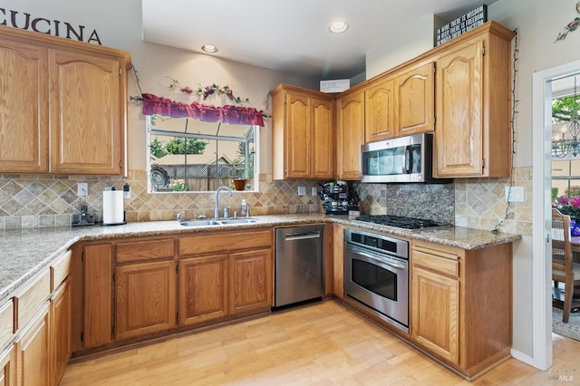 809 Muscat Ct, Petaluma, CA 94954 - kitchen with stainless steel appliances, a sink, light wood-type flooring, tasteful backsplash, and recessed lighting