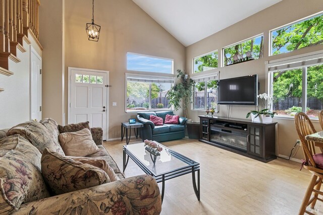 809 Muscat Ct, Petaluma, CA 94954 - living area with high vaulted ceiling, plenty of natural light, wood finished floors, a chandelier, and baseboards