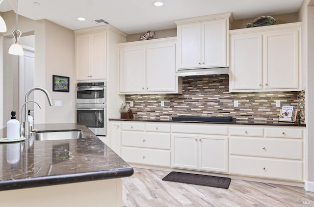 278 Longspur Dr, Rio Vista, CA 94571 - kitchen with black electric stovetop, stainless steel double oven, a sink, recessed lighting, and under cabinet range hood