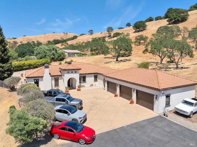 1745 Durbin Ln, Fairfield, CA 94534 - view of front of home with driveway, stucco siding, a mountain view, a tiled roof, and a garage