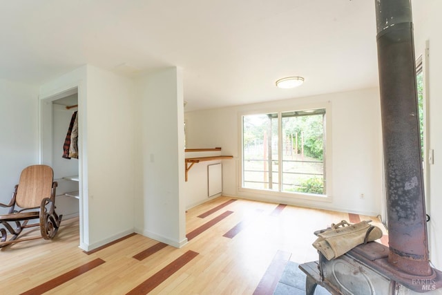 43390 Comptche Ukiah Rd, Mendocino, CA 95460 - living room with wood finished floors, a wood stove, and baseboards