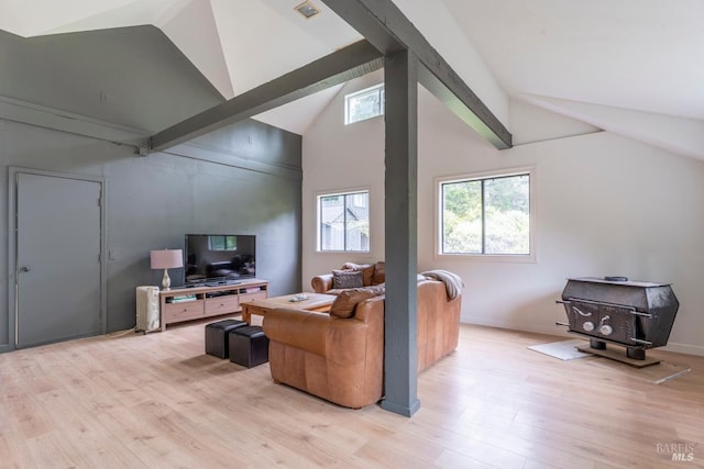 43390 Comptche Ukiah Rd, Mendocino, CA 95460 - living area featuring light wood finished floors, a wood stove, beam ceiling, and high vaulted ceiling