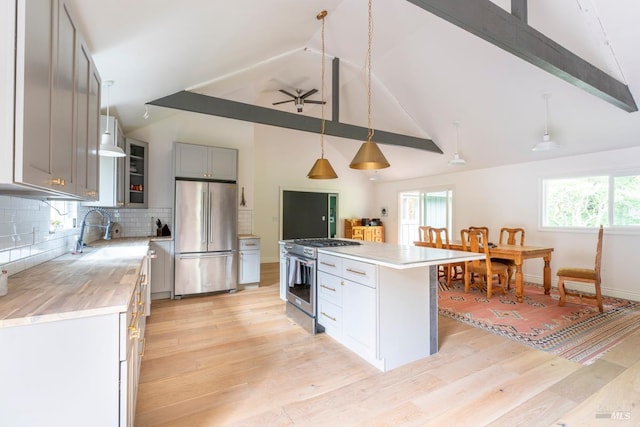 43390 Comptche Ukiah Rd, Mendocino, CA 95460 - kitchen with appliances with stainless steel finishes, a sink, light countertops, light wood-style floors, and ceiling fan