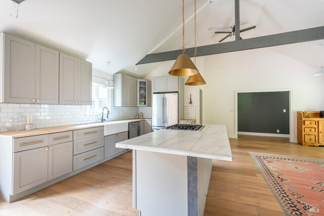 43390 Comptche Ukiah Rd, Mendocino, CA 95460 - kitchen with stainless steel appliances, gray cabinets, backsplash, ceiling fan, and light countertops