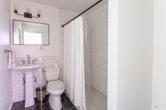 43390 Comptche Ukiah Rd, Mendocino, CA 95460 - bathroom featuring tile walls, toilet, a tile shower, and tile patterned flooring