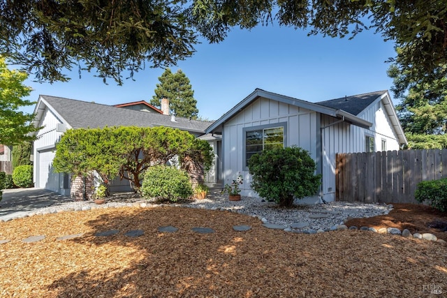 2010 Caulfield Ln, Petaluma, CA 94954 - view of front of house featuring an attached garage, a chimney, board and batten siding, and a shingled roof