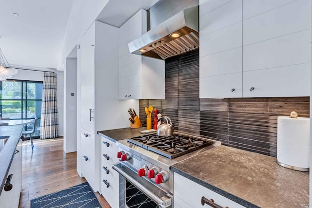 1005 Valley View St, Saint Helena, CA 94574 - kitchen featuring high end stainless steel range oven, wall chimney exhaust hood, tasteful backsplash, dark countertops, and white cabinets