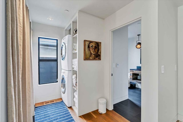 1005 Valley View St, Saint Helena, CA 94574 - washroom featuring stacked washing machine and dryer, wood finished floors, and baseboards