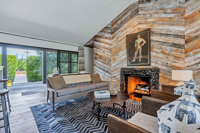 1005 Valley View St, Saint Helena, CA 94574 - living area with wooden walls, high vaulted ceiling, a warm lit fireplace, and wood finished floors