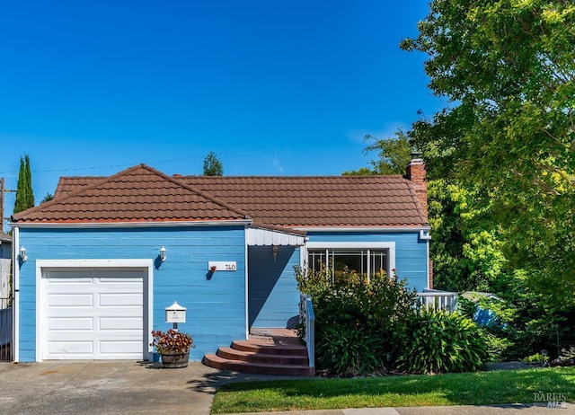 740 Valle Vista Ave, Vallejo, CA 94590 - view of front of house with a chimney, a tile roof, a garage, and concrete driveway