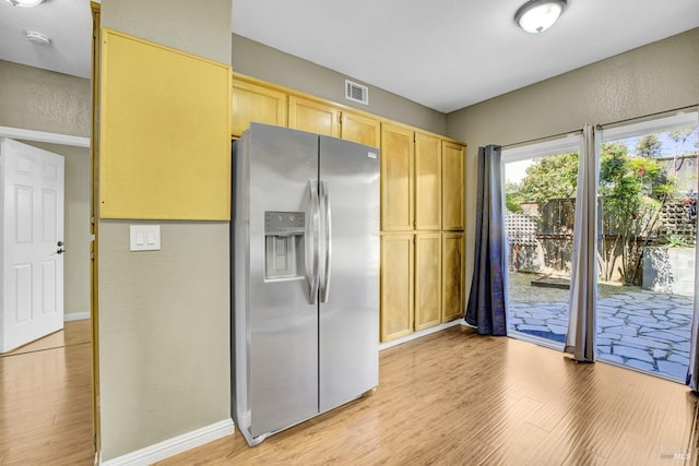 115 Barington Dr, Vallejo, CA 94591 - kitchen featuring stainless steel fridge with ice dispenser, light wood finished floors, baseboards, a textured wall, and light brown cabinets